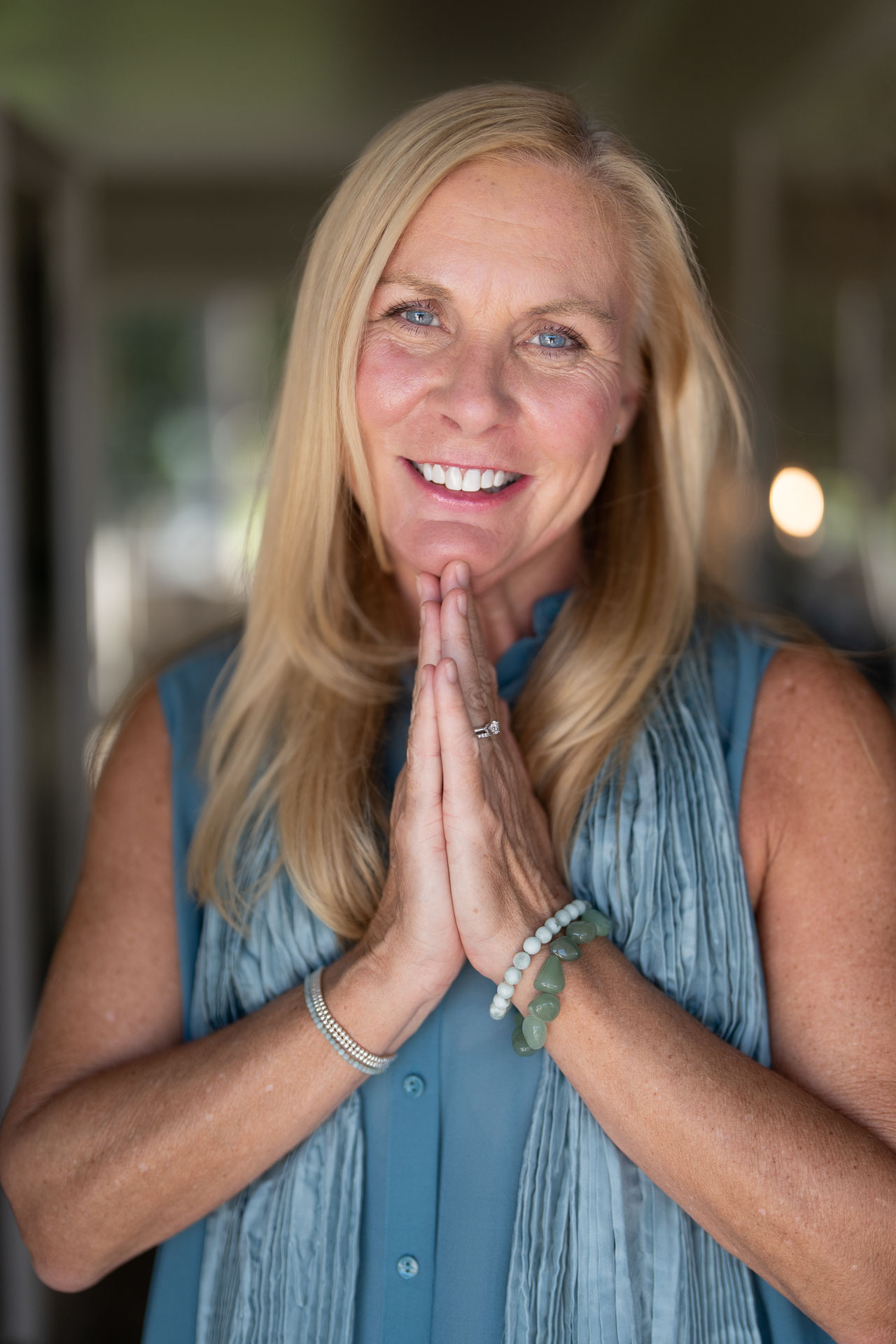 Smiling woman with hands pressed together