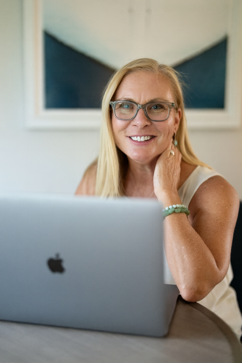 Smiling professional woman with laptop and glasses